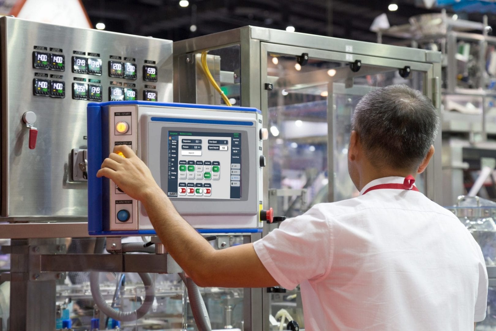 factory engineer controlling and pressing important technology button at control panel of an automatic machine in the manufacturing.